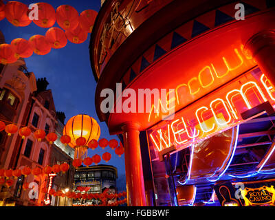 CHINATOWN SOHO Chinese lanterns lit up on a busy night in Wardour Street with neon 'Welcome' sign Chinatown Soho London UK Stock Photo