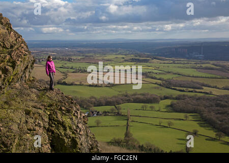 Woman on the Wrekin hill in Shropshire, England. Cooling towers of the Ironbridge Power station in the far distance. Stock Photo