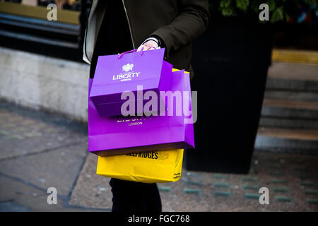 London, UK. 23rd December 2015 - Christmas shopper with shopping bags in Regent Street in London's West End. Stock Photo