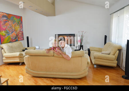 Relaxed young  couple watching tv at home Stock Photo