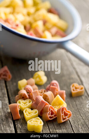 heart shaped pasta on old wooden table