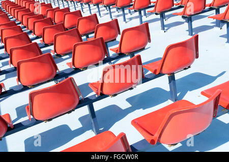 Rows of empty red seats on the upper deck of a passenger ferry Stock Photo