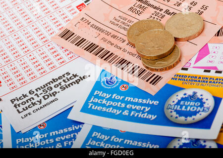 Close up of National Lottery Lotto Euro Millions tickets money and slips ticket slip England UK United Kingdom GB Great Britain Stock Photo