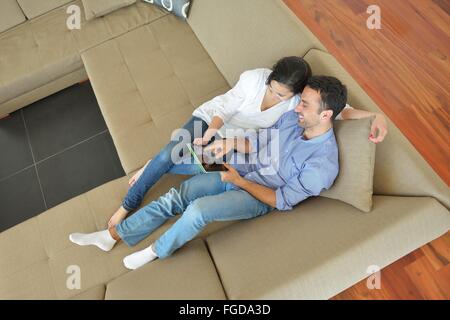 couple at home using tablet computer Stock Photo