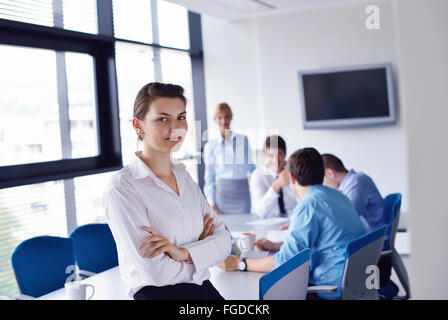 business woman with her staff in background at office Stock Photo
