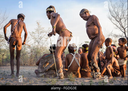 Kalahari San people dancing in circles around people sitting down on the ground and singing. Stock Photo