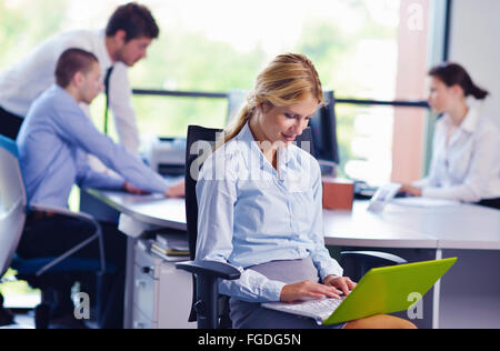 business woman with her staff in background at office Stock Photo