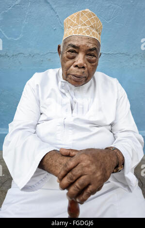 Portrait of an old man with a muslim hat and a walking stick. Stock Photo