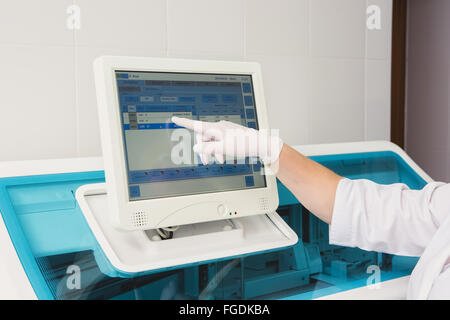 Lab tech loading samples into a chemistry analyzer Stock Photo - Alamy