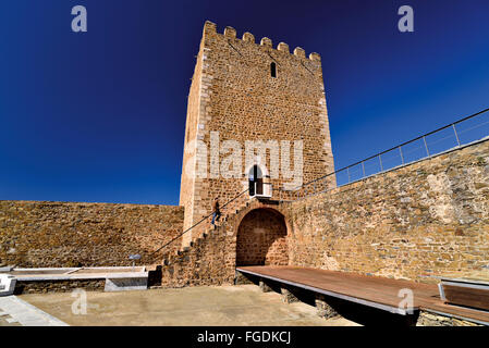 Portugal, Alentejo: Man climbing the steps to the main tower of Mértola Castle Stock Photo