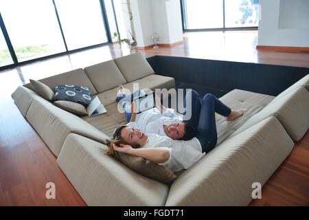 couple at home using tablet computer Stock Photo