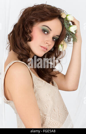 Young woman with flower arrangement as a headdress