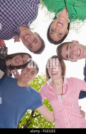 young friends staying together outdoor in the park Stock Photo