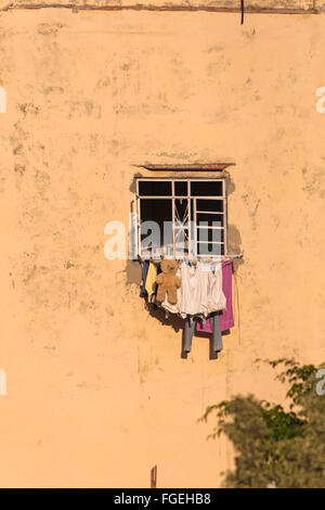 Daily life in Cuba - washing and teddy bear hanging outside window at Havana, Cuba, West Indies, Caribbean, Central America Stock Photo