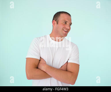 Man with folded arms, smiling Stock Photo