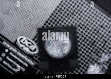 Looking at snow crystals with loupe to analyze snow pack and measure the safety Stock Photo