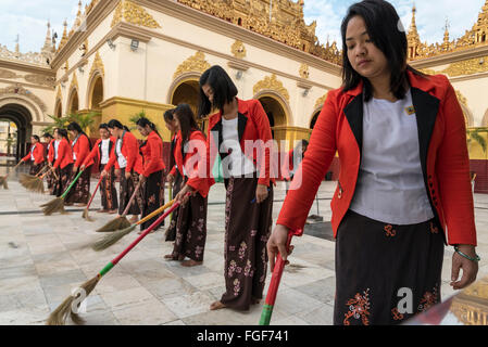 Burmese women sweep the floor around the Mahamuni Paya in Mandalay, Burma - Myanmar Stock Photo