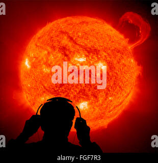 computer generated man listening on sun sounds on head phones Stock Photo