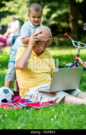 grandfather and child using laptop Stock Photo