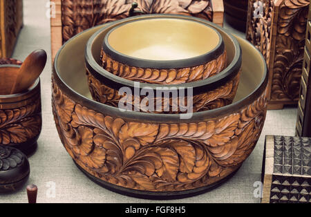 Original dishes made of wood, decorated with carvings. Handmade. Stock Photo