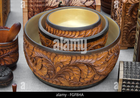 Original dishes made of wood, decorated with carvings. Handmade. Stock Photo