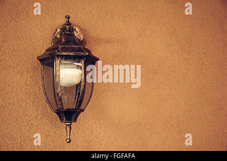 Old beautiful lantern an orange nice wall Stock Photo