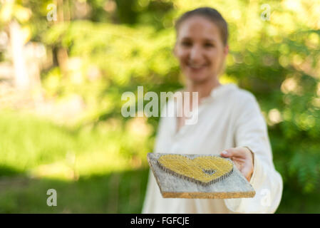 Take my heart with love - Conceptual giving of symbolic heart with one hand Stock Photo