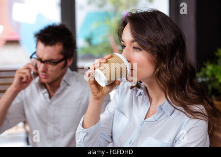 People using smartphone and drinking coffee Stock Photo