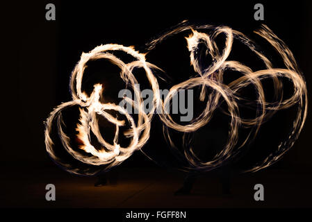 Fire poi in action by a male performance in Thai restaurant Stock Photo