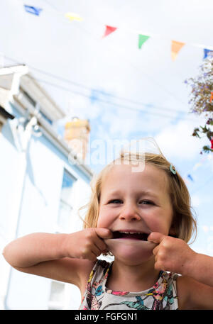 Girl pulling a cheeksface Stock Photo