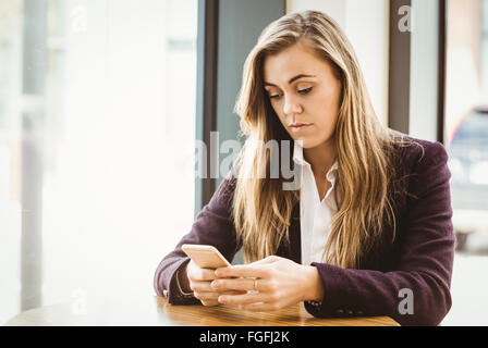 Cute blonde girl texting Stock Photo