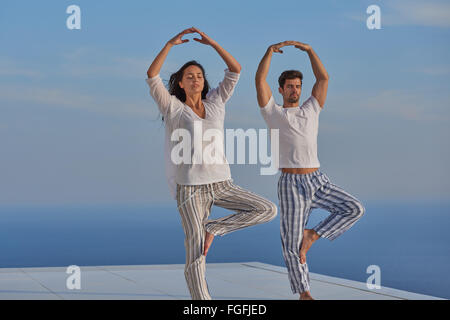 young couple practicing yoga Stock Photo