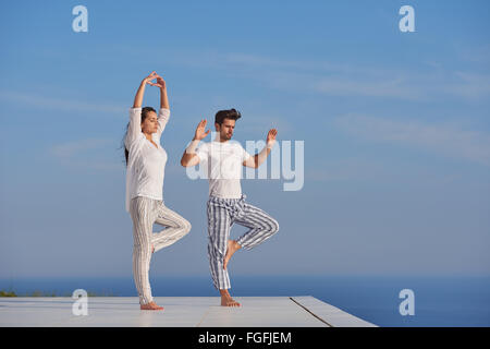 young couple practicing yoga Stock Photo