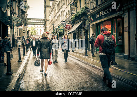 Street scene in the Charing Cross district of London on damp day with people visible. Stock Photo