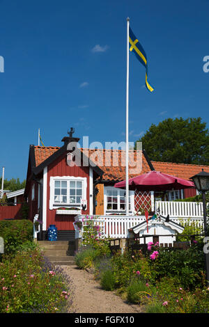 Traditional Swedish red summer house in Brandaholm, Dragso Island, Karlskrona, Blekinge, South Sweden, Sweden, Scandinavia Stock Photo