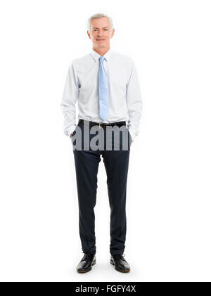 Full length portrait of senior businessman standing against white background. Stock Photo