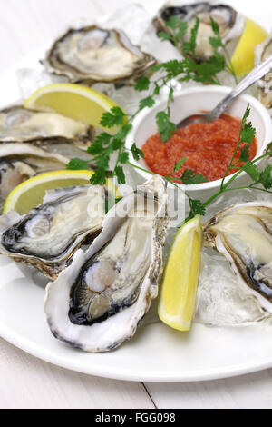 fresh oysters plate isolated on white wooden background Stock Photo