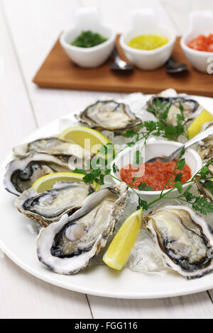 fresh oysters plate isolated on white wooden background Stock Photo