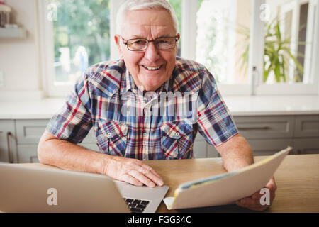 Happy senior man using laptop Stock Photo