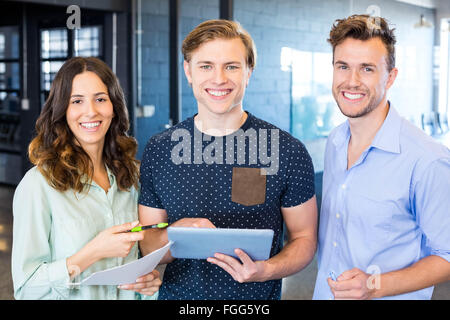 Three confident colleagues discussing in office Stock Photo