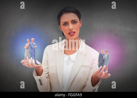 Composite image of serious businessman standing back to back with a woman Stock Photo