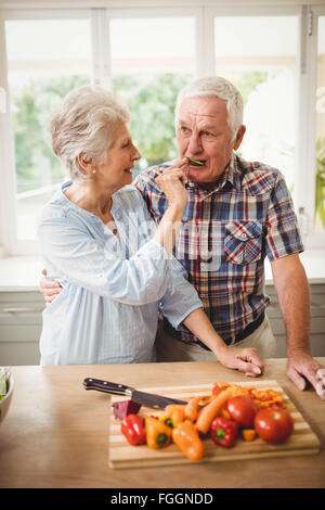 Happy senior couple in kitchen Stock Photo