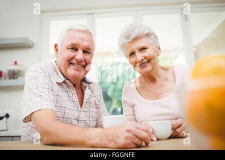 Portrait of senior couple smiling while having coffee Stock Photo