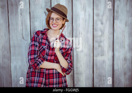 smiling hipster woman holding a pencil Stock Photo