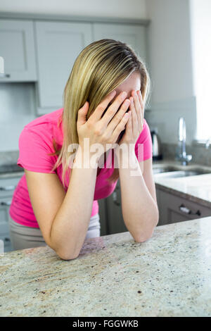 Tired blonde woman with migraine Stock Photo