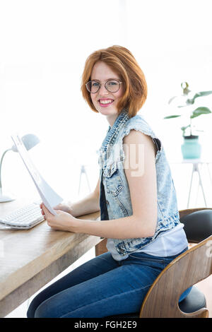 smiling hipster woman holding paperwork Stock Photo