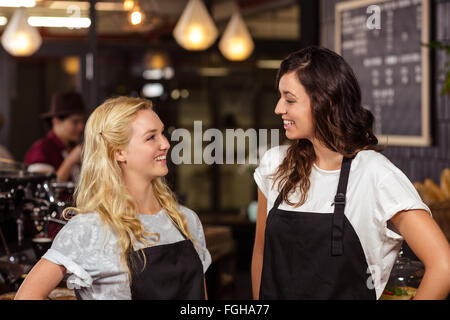 Pretty waitresses posing in front of the counter Stock Photo