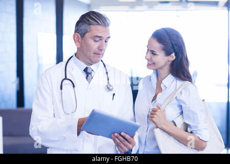 Doctor using digital tablet and having a discussion Stock Photo