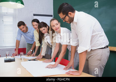 Team of architects going over blueprints Stock Photo