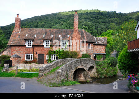 Allerford village, stone built cottage with stone bridge and ford, Somerset,UK Stock Photo